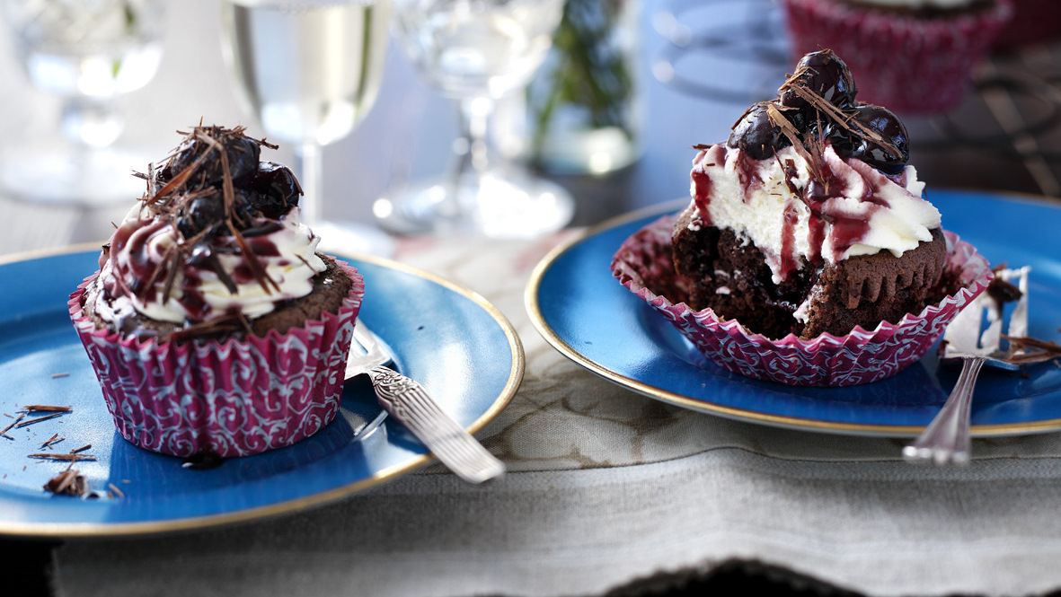 Black Forest Cake on blue cake stand in front of grey background Stock  Photo - Alamy