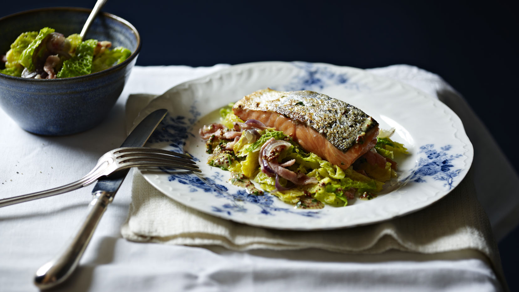 Grilled salmon, braised cabbage with bacon and onions-image